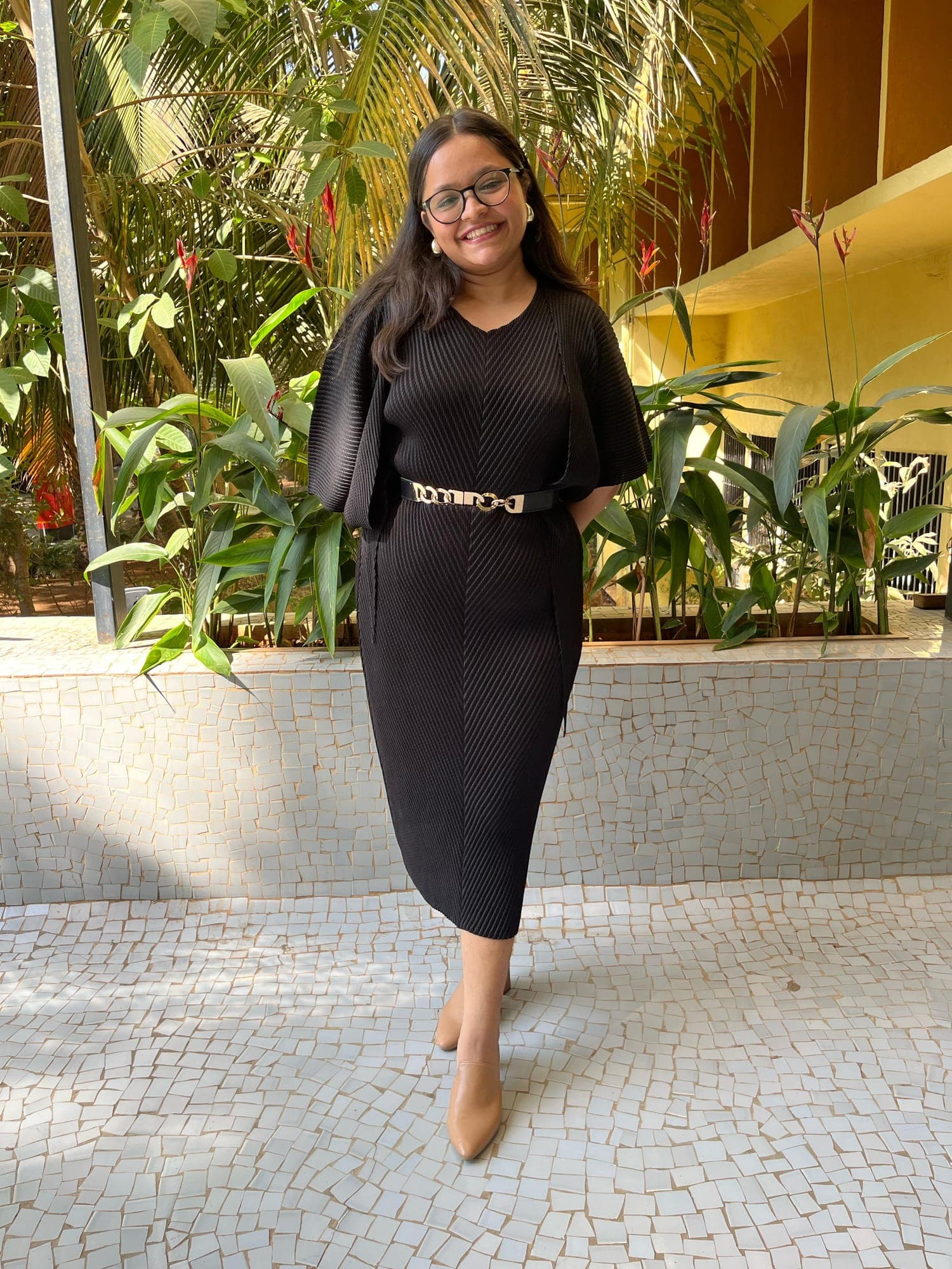 Irika Goyal, clinical dietitian, standing outdoors among tropical plants